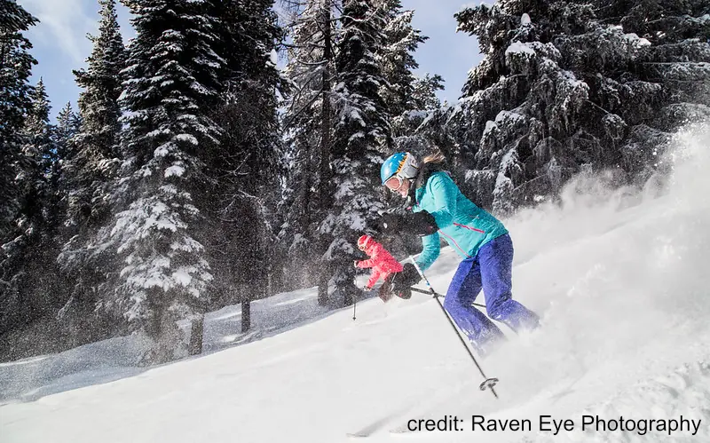 2 skiers descending a groomed run in Kimberly, BC