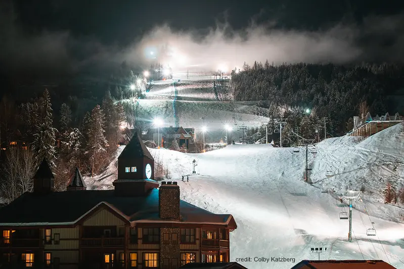 view of the chairlift and lights on for night skiing at Kimberly resort