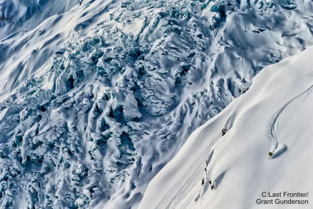 skier on steep terrain with Bell 2 Lodge heliskiing