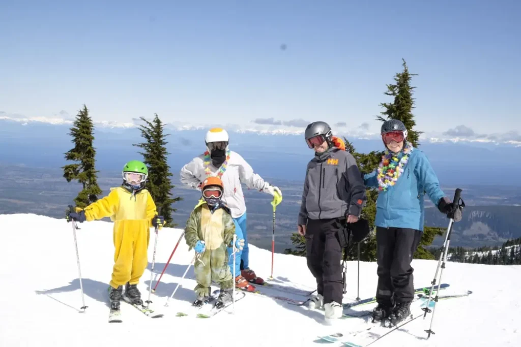 Family posing atop Mt. Washington Alpine Resort ski area