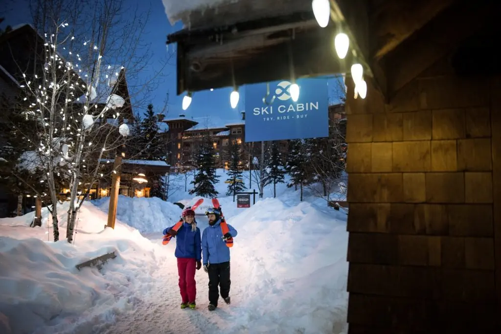 Skiers walking through Panorama village at night