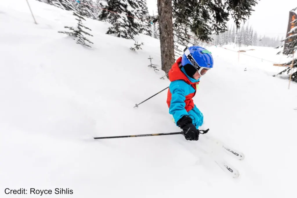 young kid skiing powder in Revelstoke