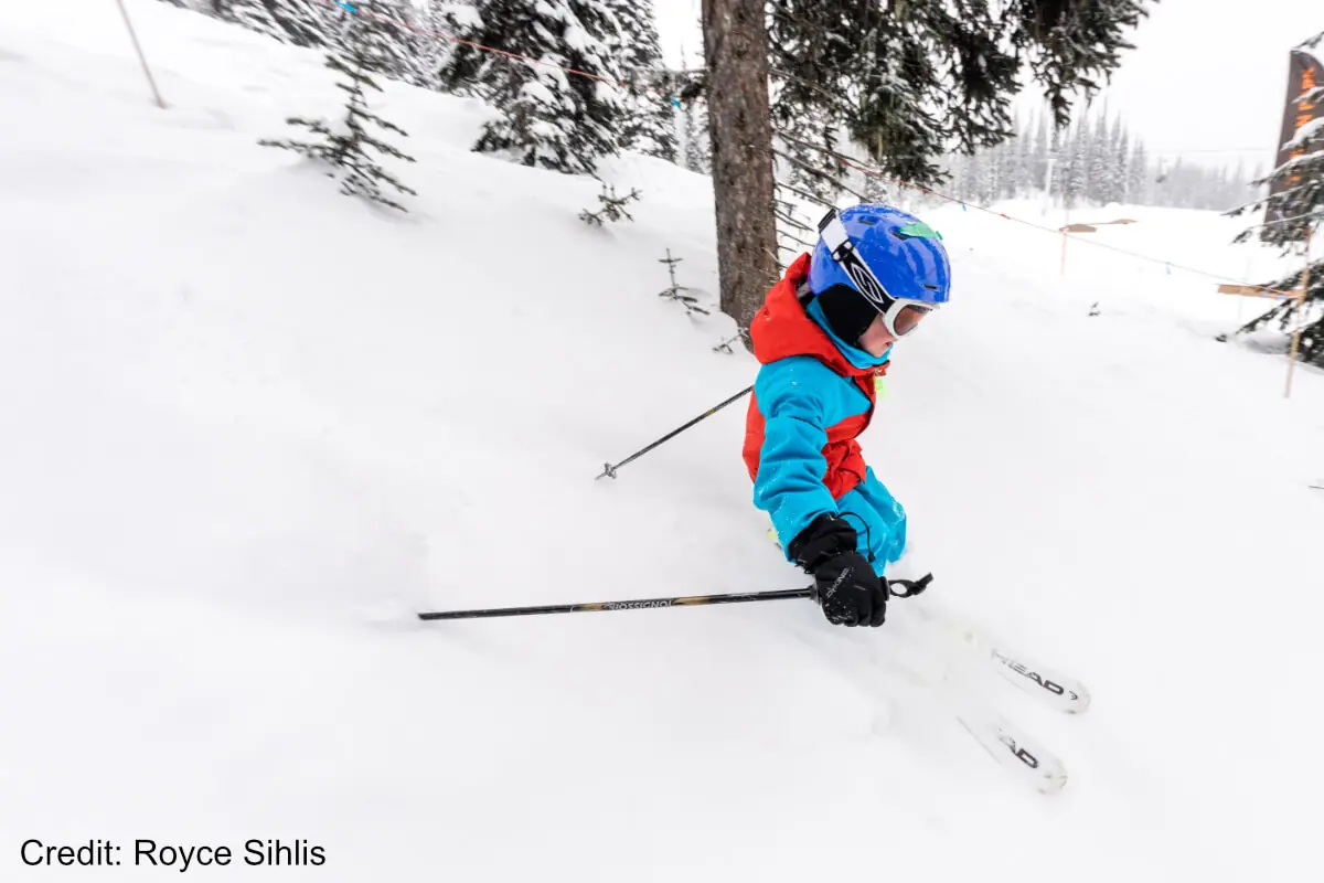 young kid skiing powder in Revelstoke
