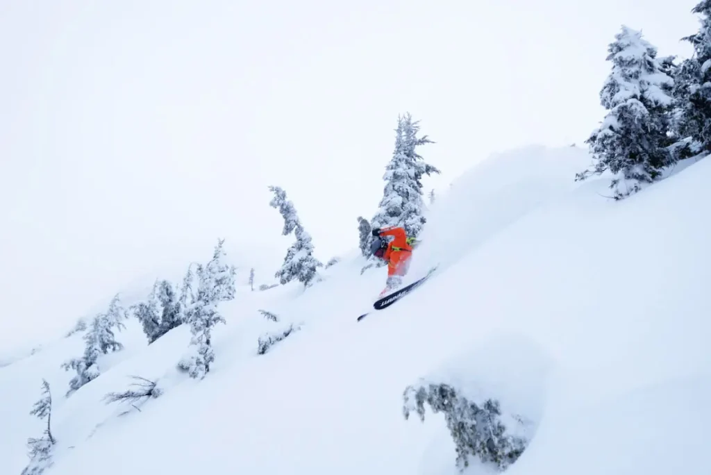 heli skier in deep powder near Revelstoke