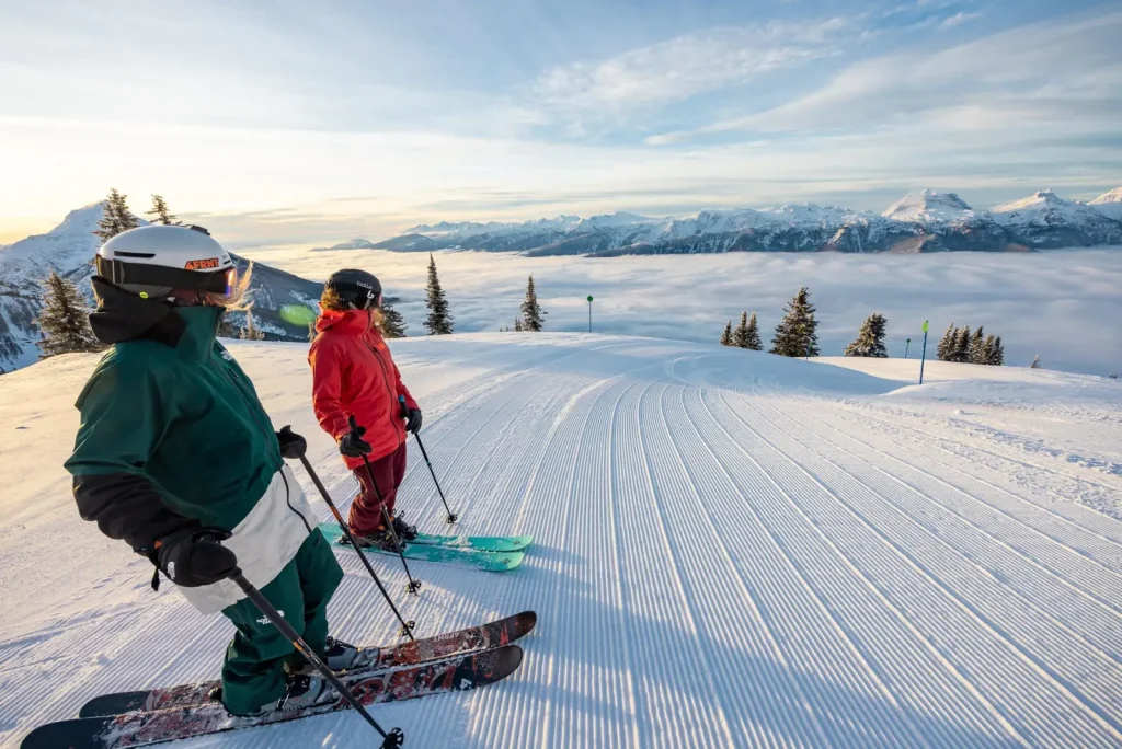 skiers atop a groomed run at Revelstoke Resort