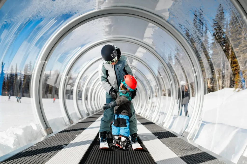 parent and child riding the magic carpet lift at Revelstoke Resort