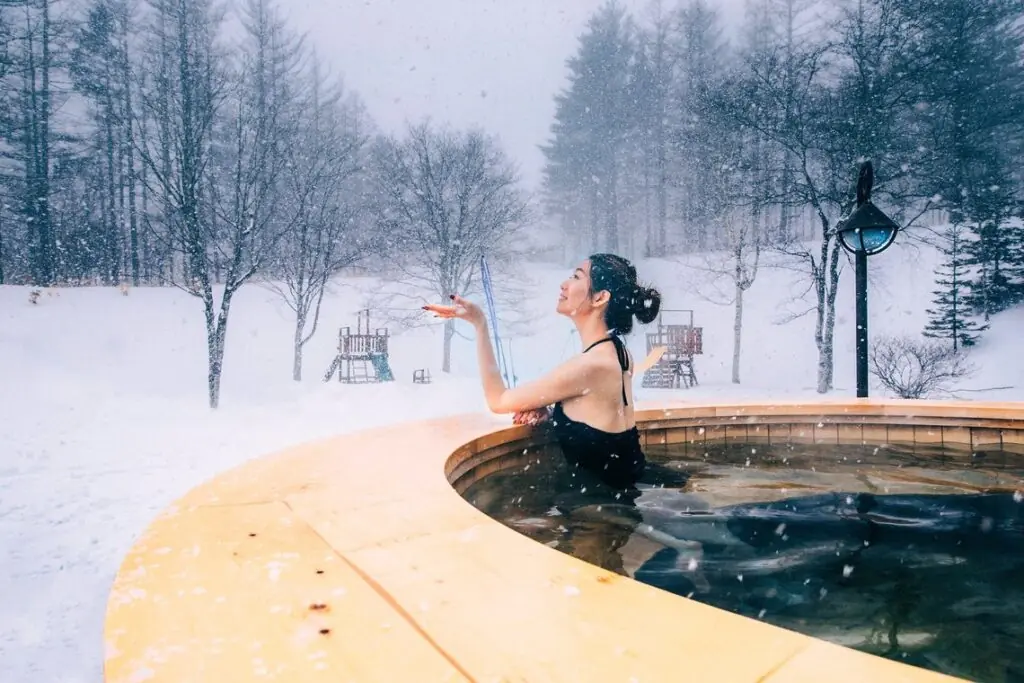 woman in hot tub on snowy day in Sahoro