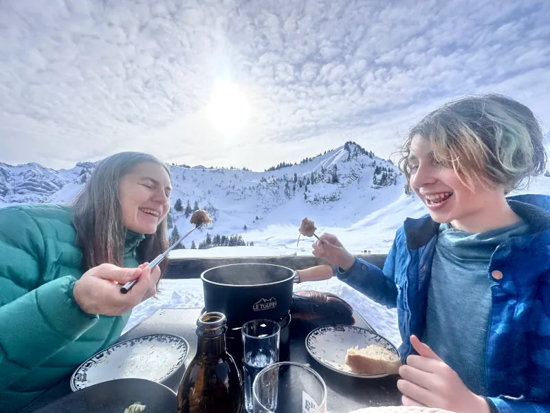 Zachary and his mom enjoying a snack at the ski hill
